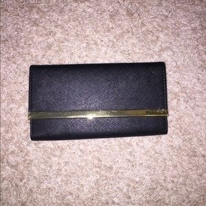 Brand new! Still has plastic. Black/Gold wallet!